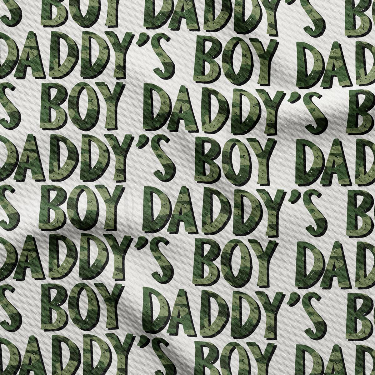 a green camouflage print fabric with the words daddy&#39;s boy&#39;s