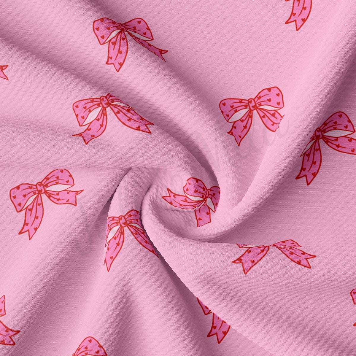 a pink fabric with pink bows on it