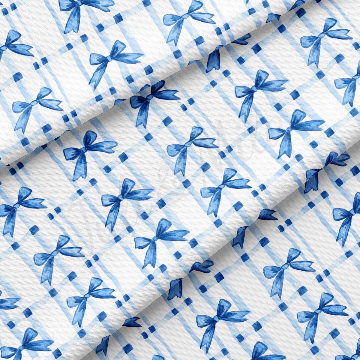 a blue and white checkered fabric with blue bows