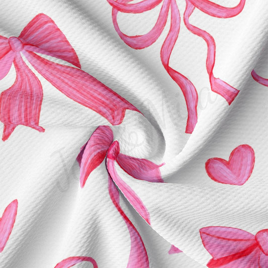 a pink and white fabric with hearts on it