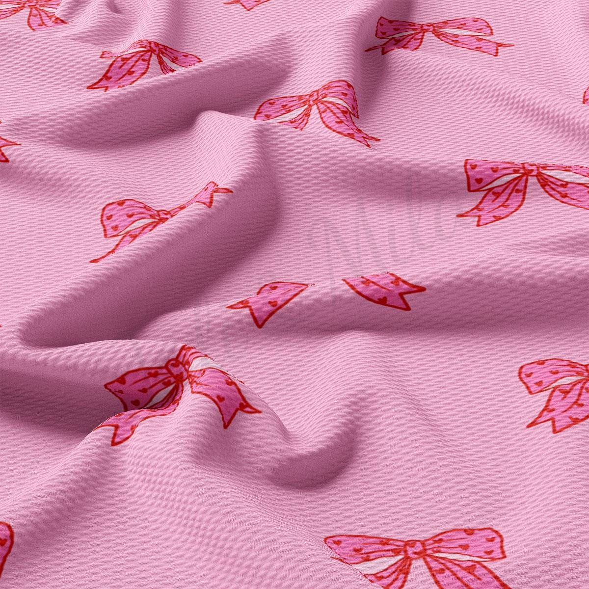 a pink fabric with pink bows on it