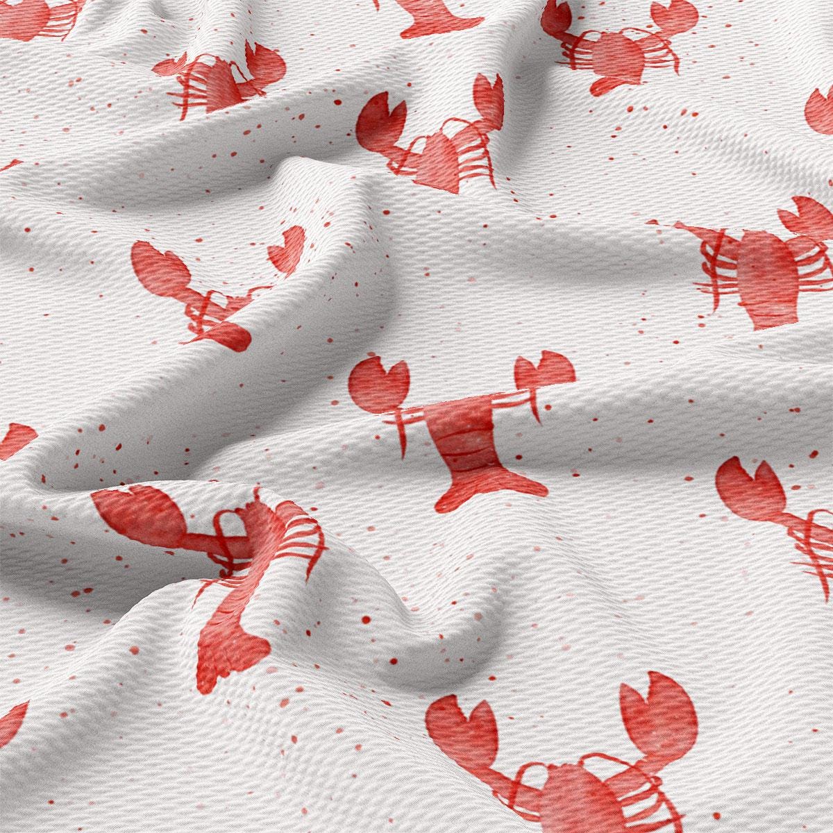 a close up of a red and white fabric with lobsters on it