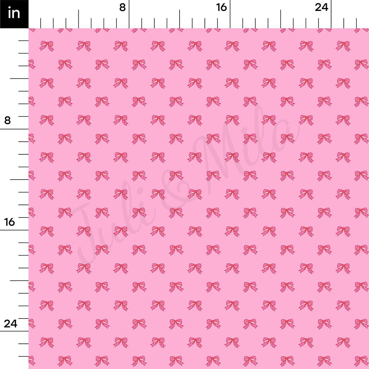 a ruler with a pink bow pattern on it