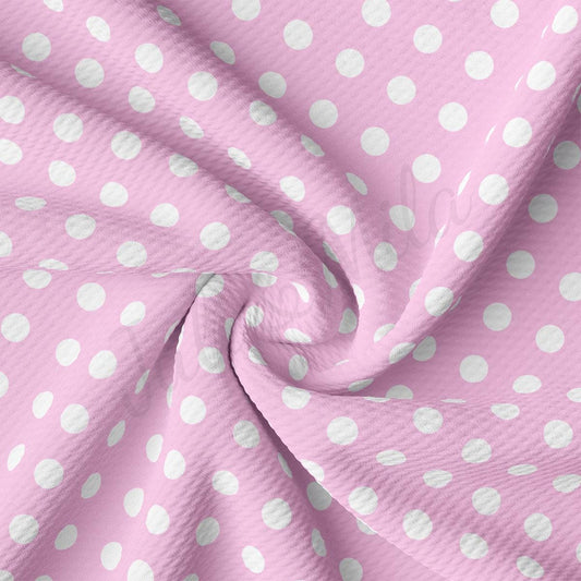 a pink and white polka dot fabric