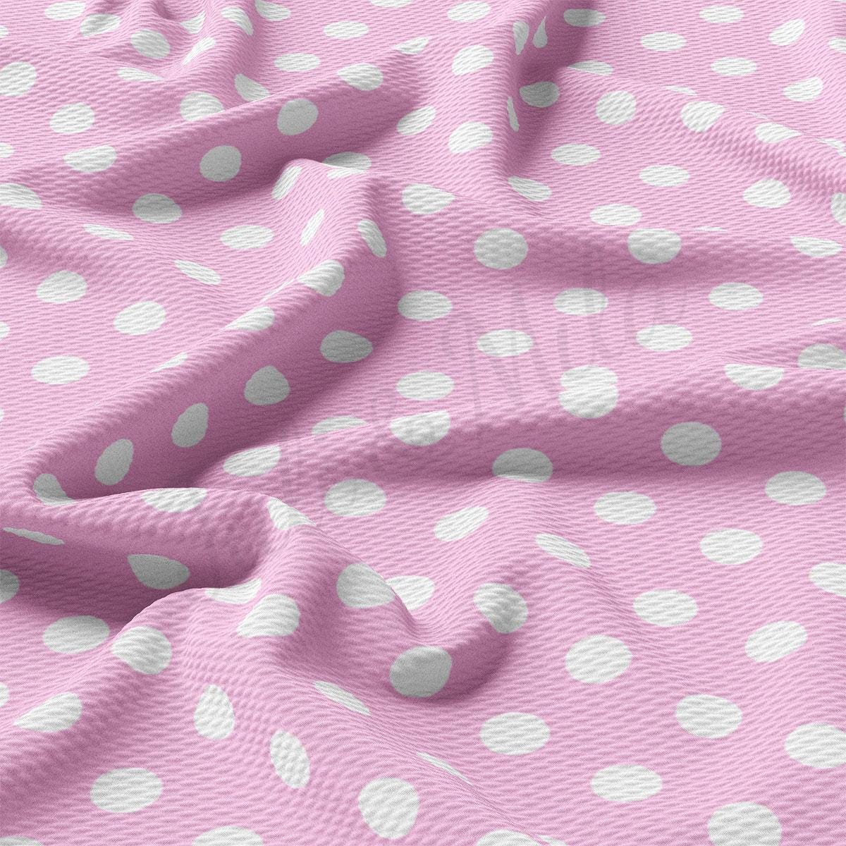 a pink and white polka dot fabric