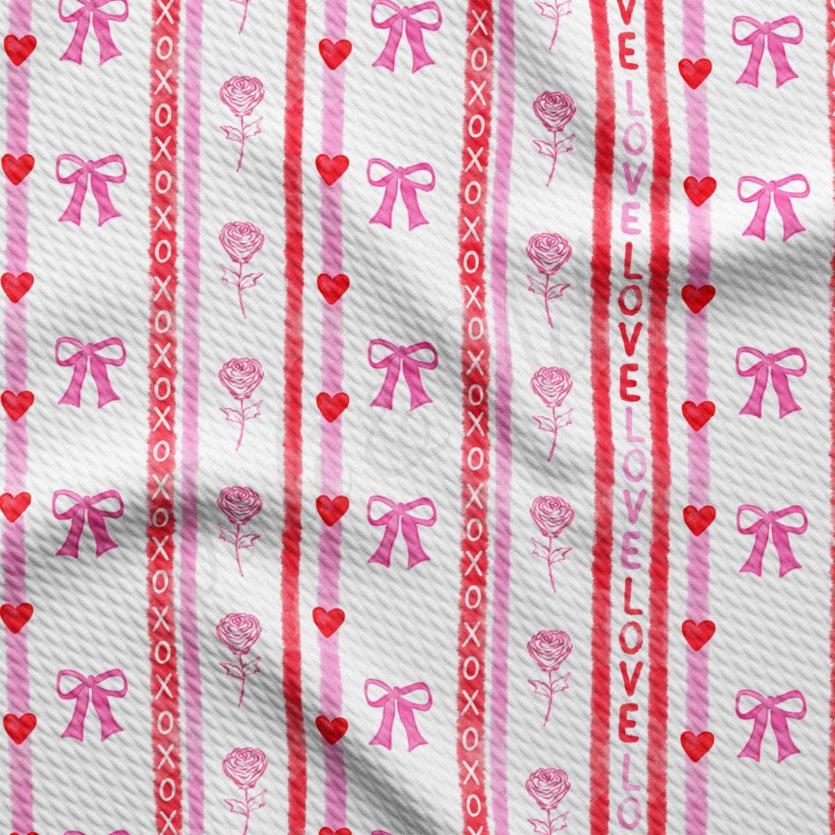 a close up of a red and white striped fabric with hearts and bows