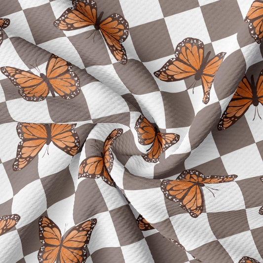 a checkered pattern with orange butterflies on it