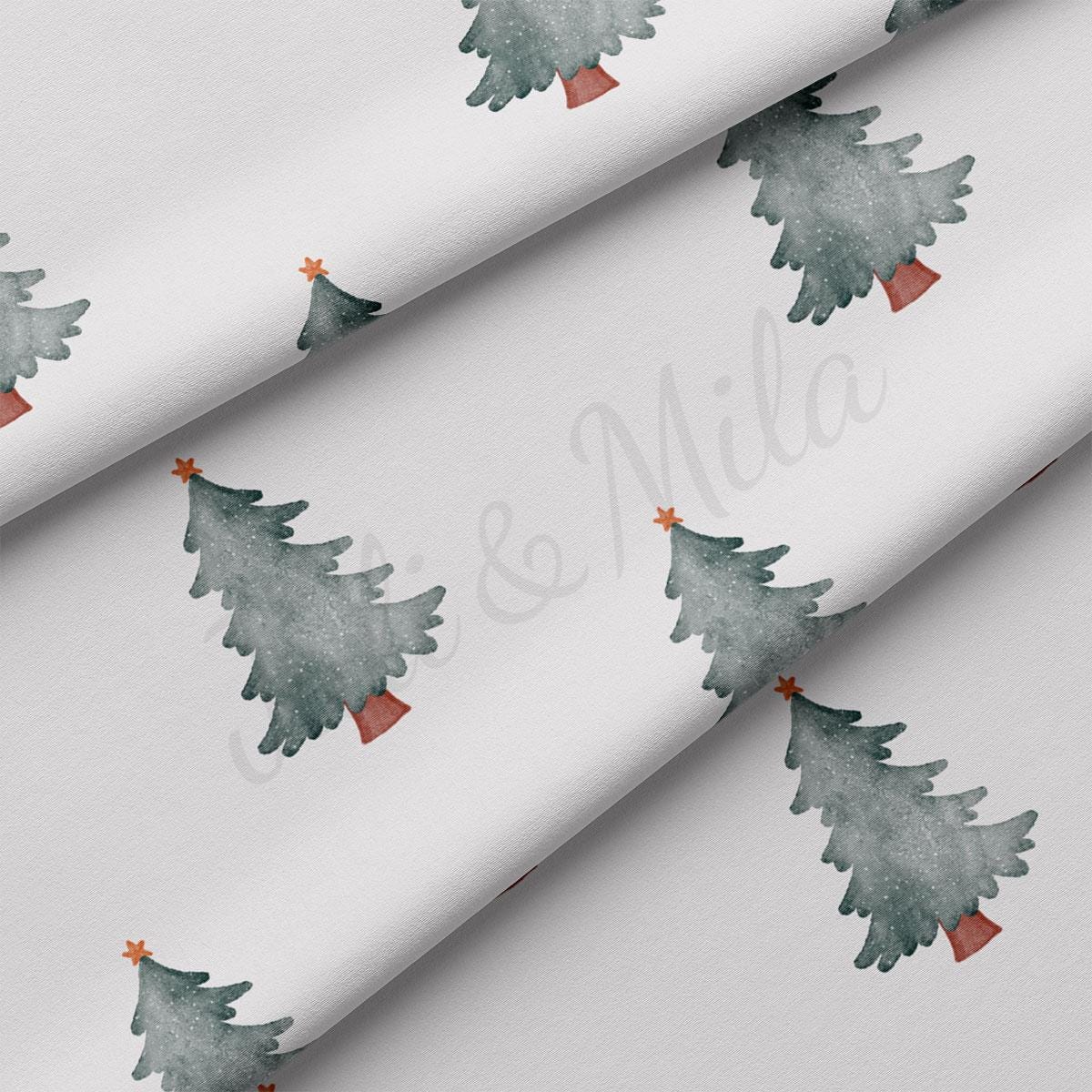 a white wrapping paper with watercolor christmas trees on it