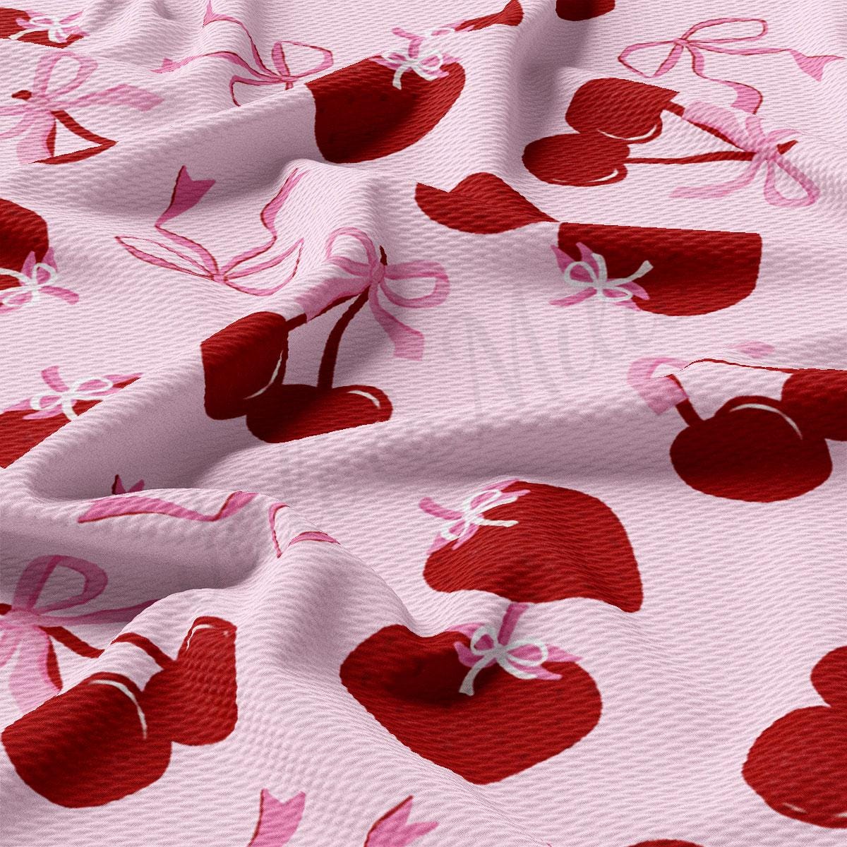 a close up of a pink fabric with cherries on it