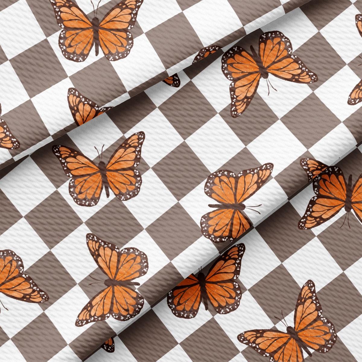 a checkered pattern with orange butterflies on it