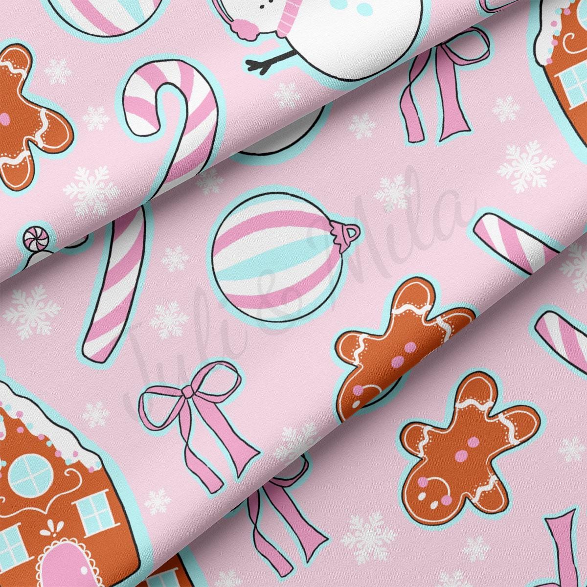 a pink background with gingerbreads and candy canes