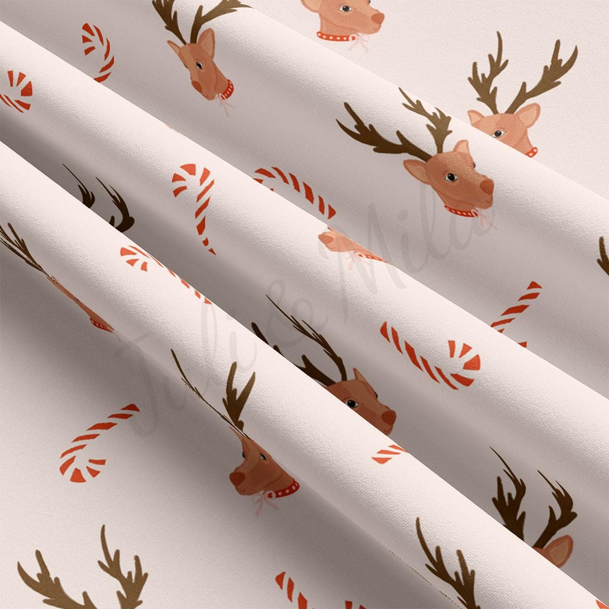 a white wrapping paper with reindeers and candy canes on it