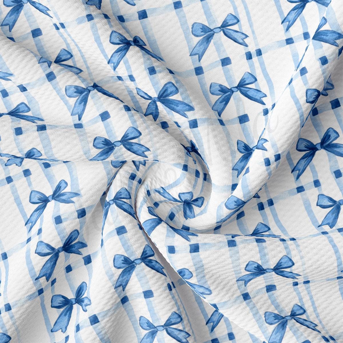 a blue and white checkered fabric with bows