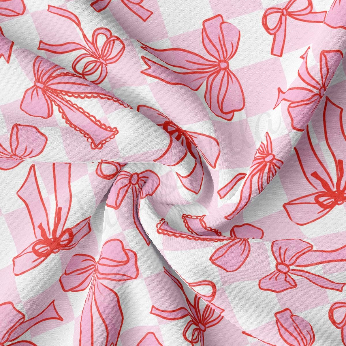 a pink and white checkered fabric with red flowers