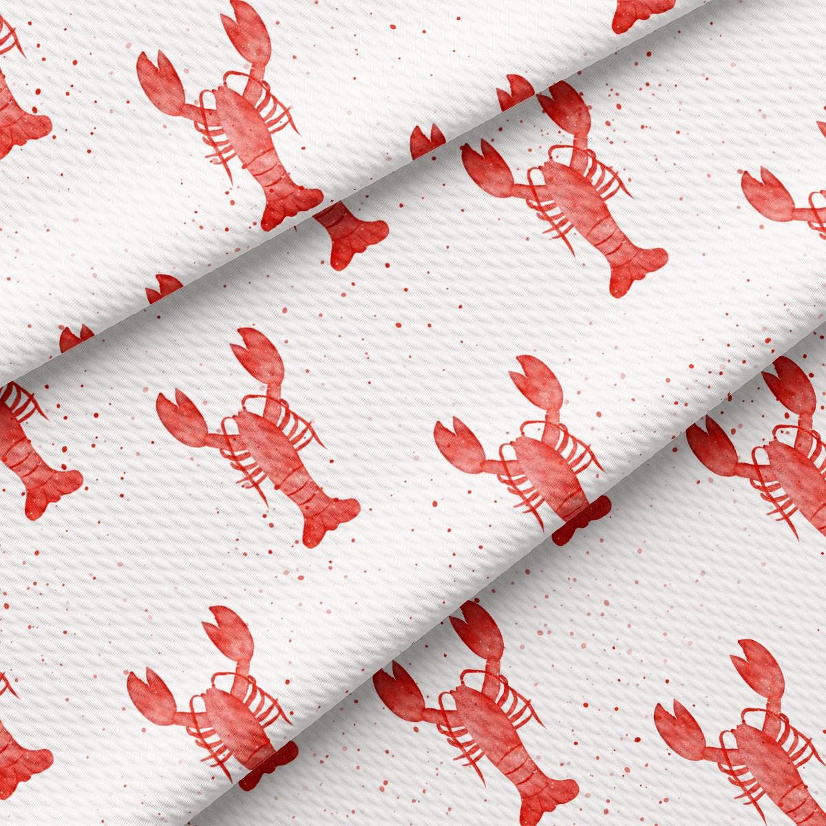 a red lobster pattern on white fabric