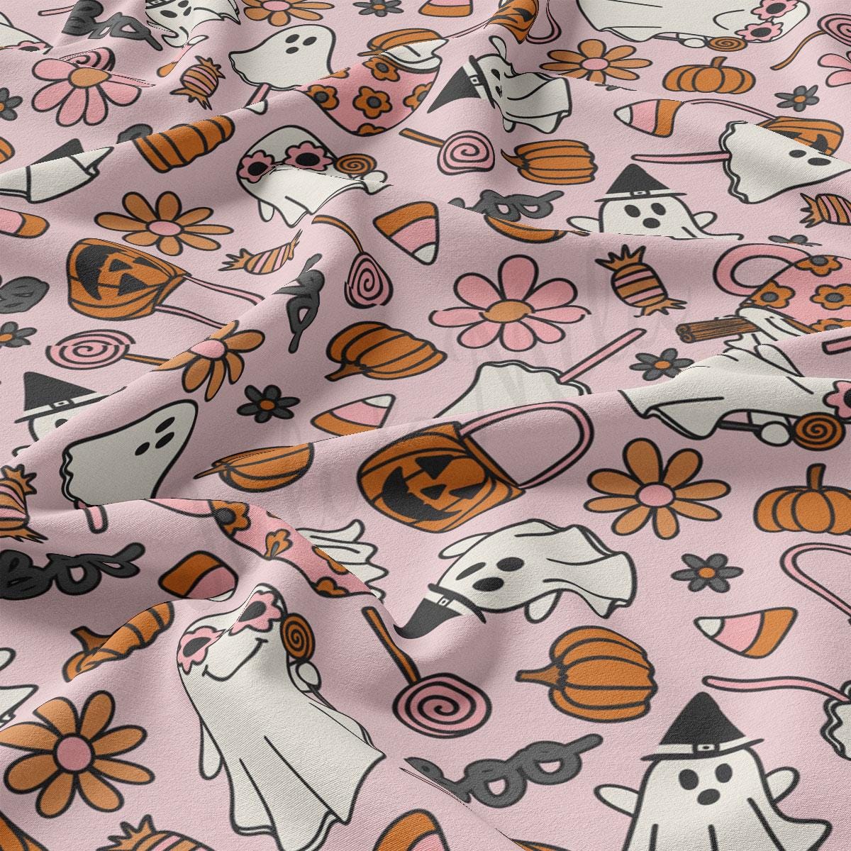 a pink background with a pattern of cats and pumpkins