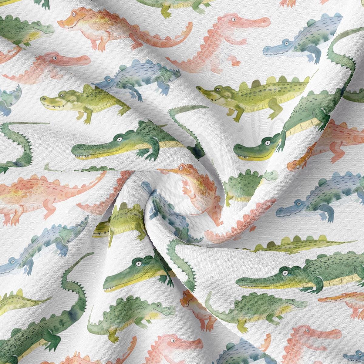 a white fabric with colorful alligators on it