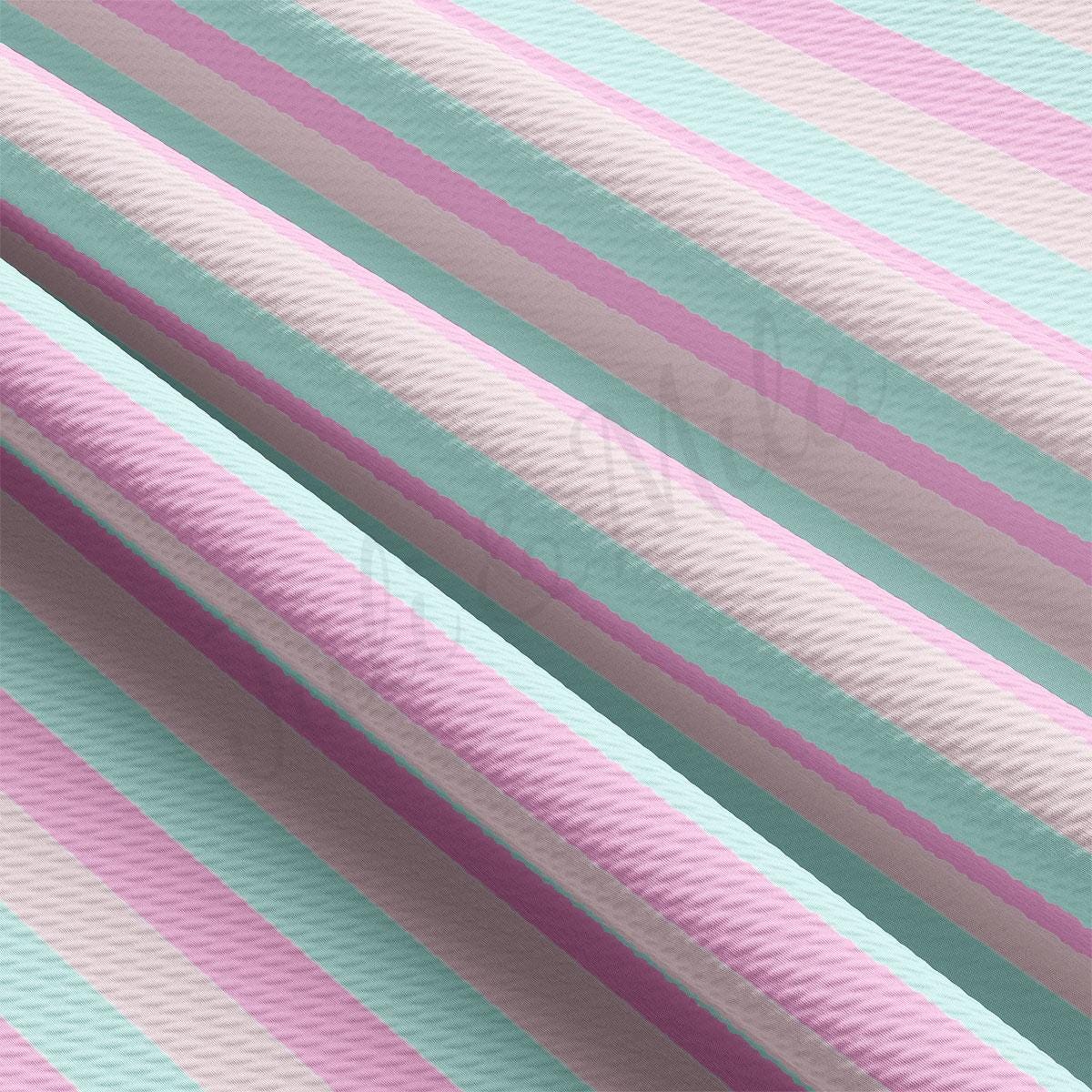 a close up of a pink and blue striped wallpaper