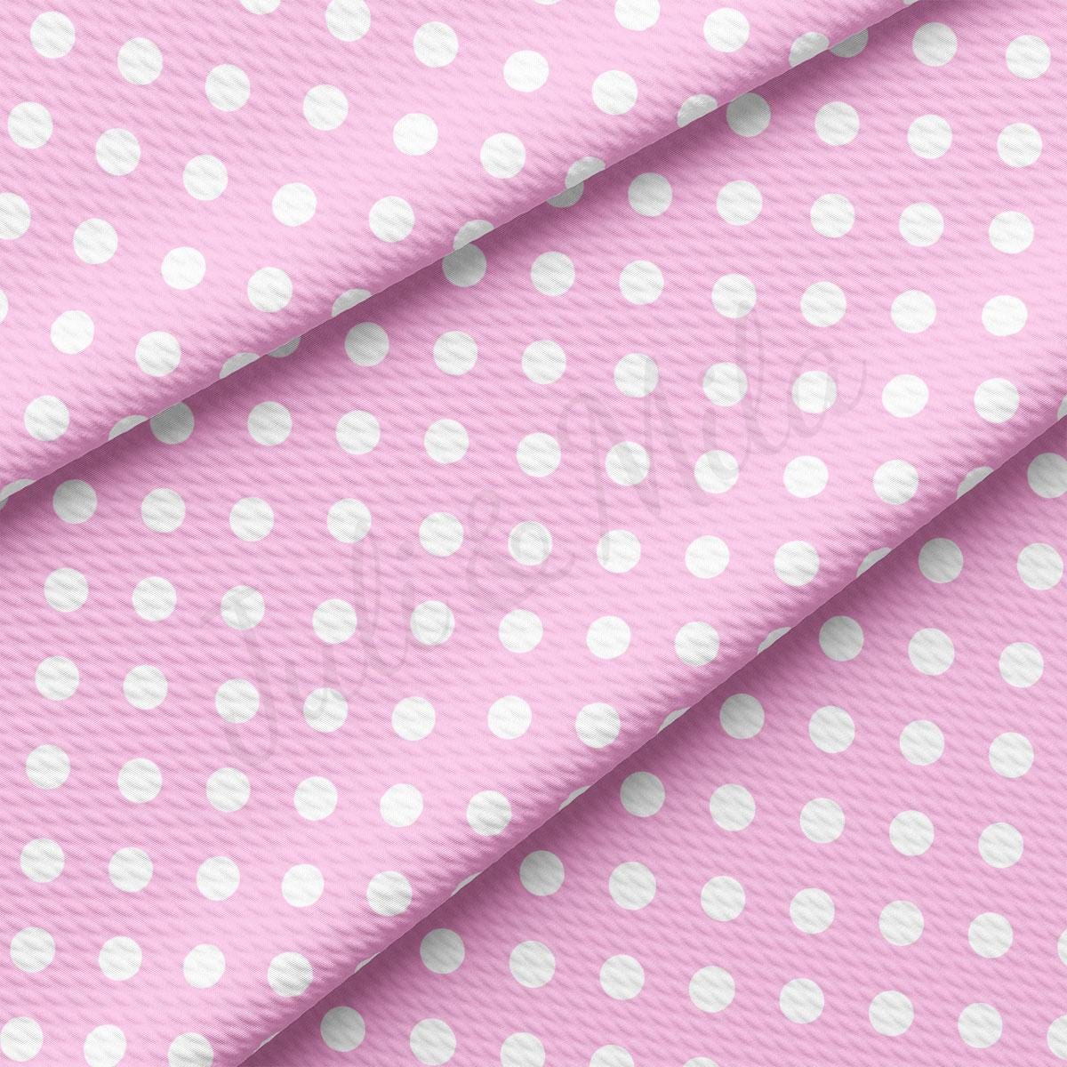 a pink and white polka dot fabric