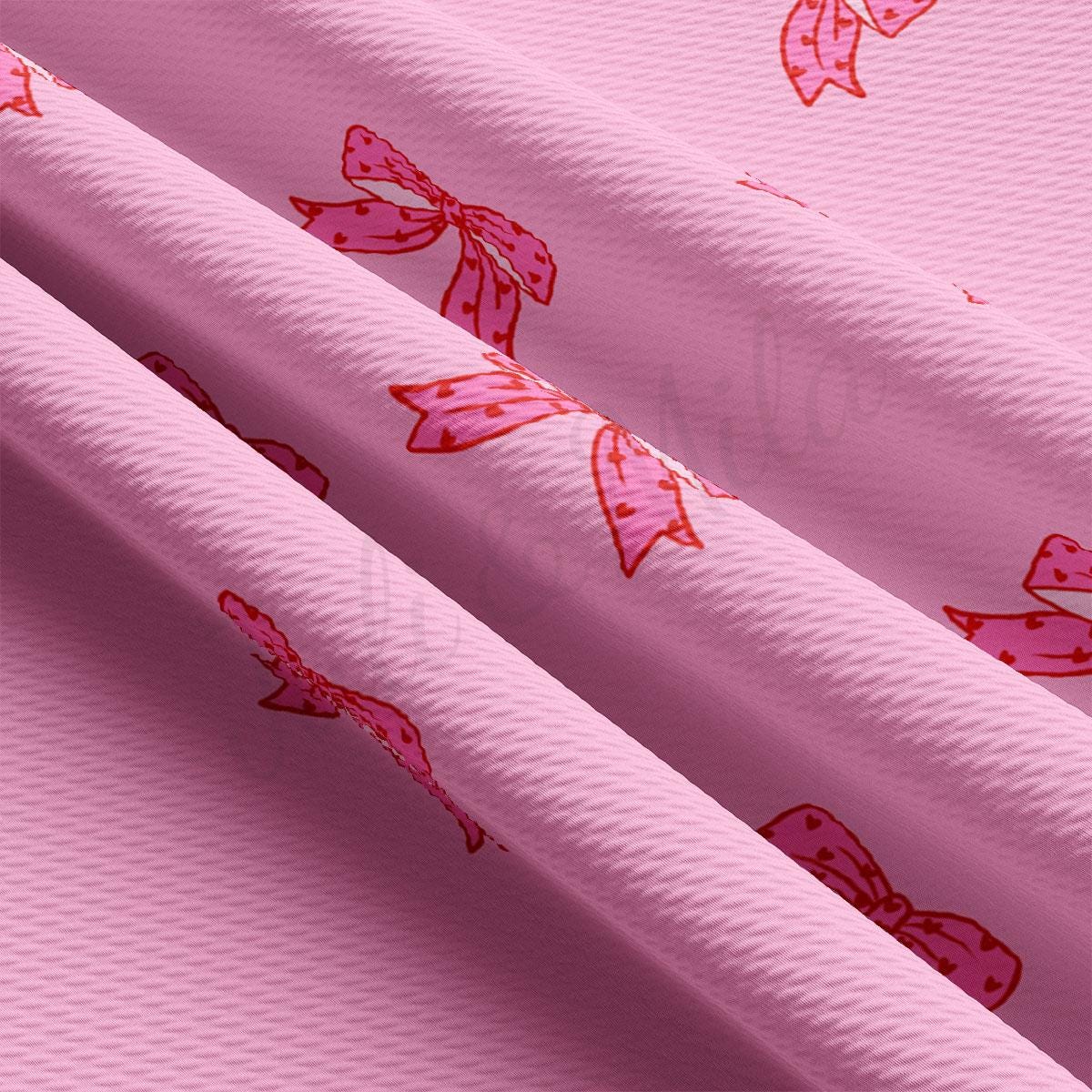 a close up of a pink background with bows