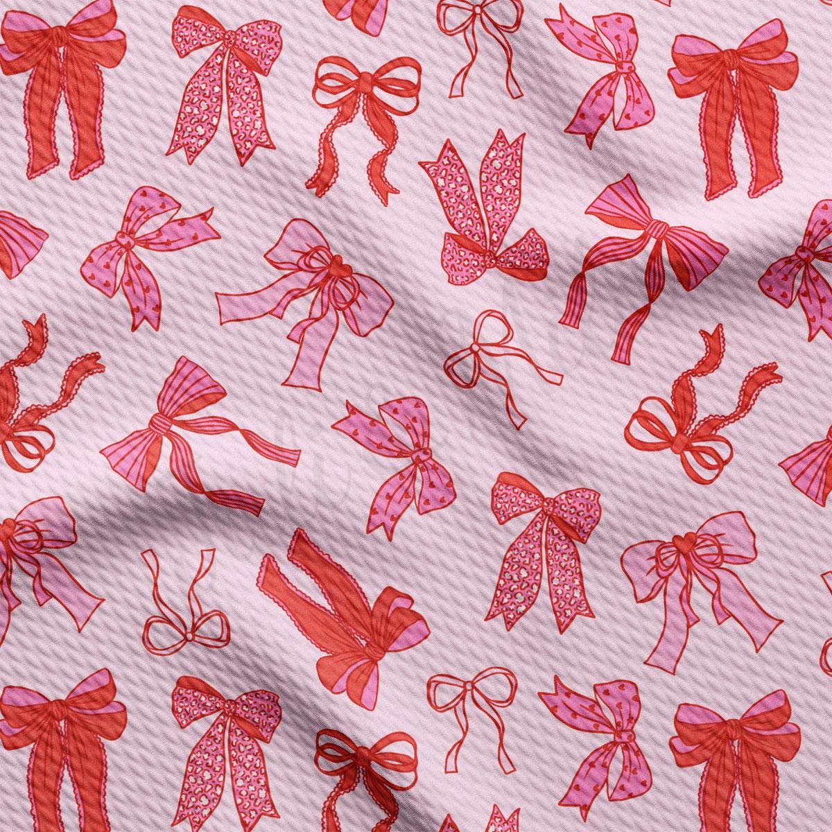 a pink and red pattern of bows and bows