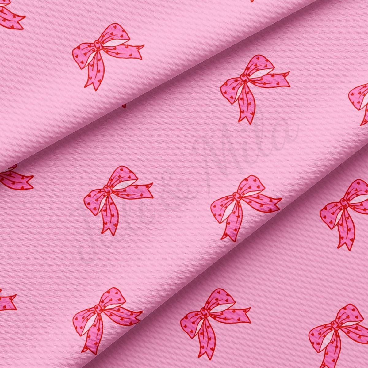 a pink fabric with pink bows on it