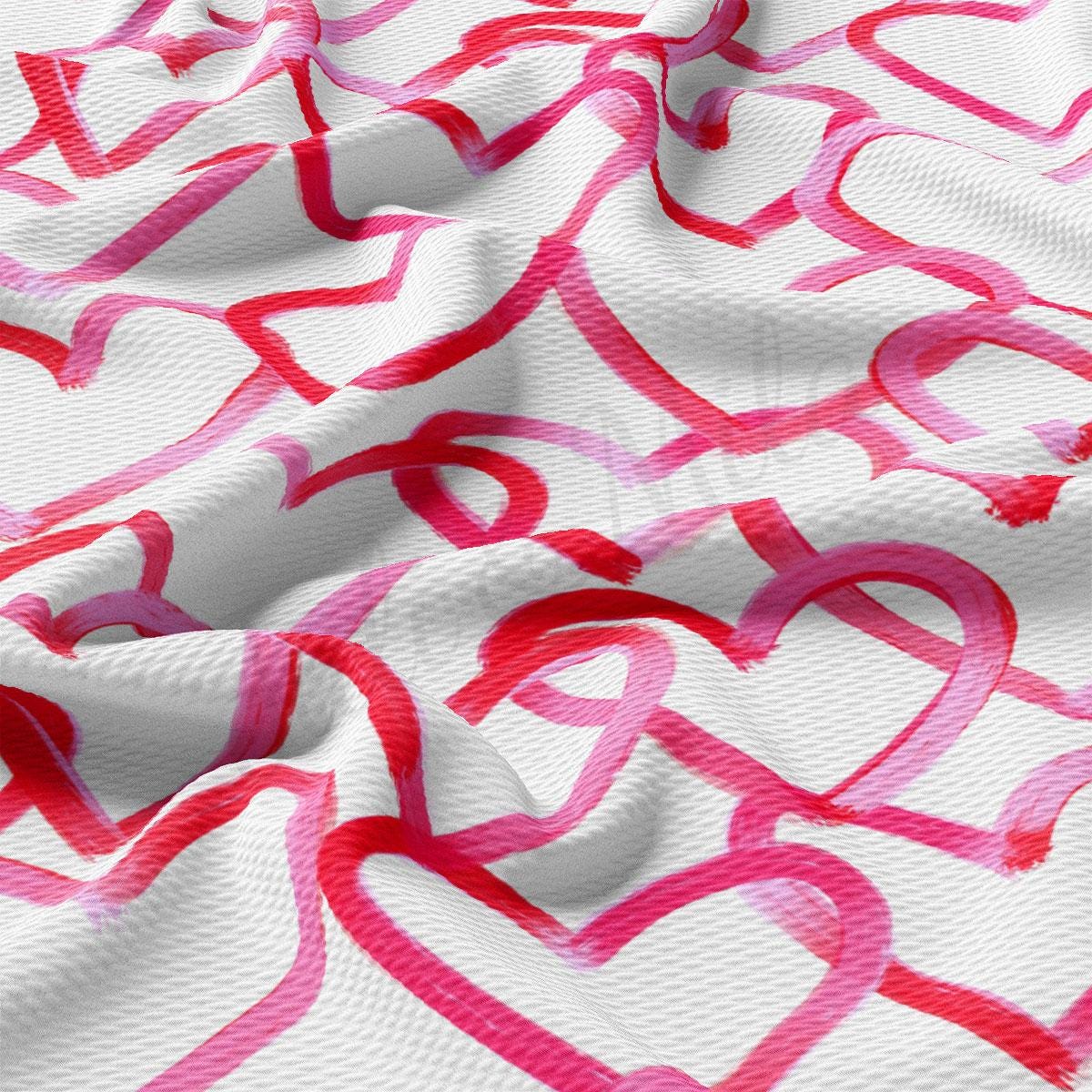 a white and pink fabric with hearts on it