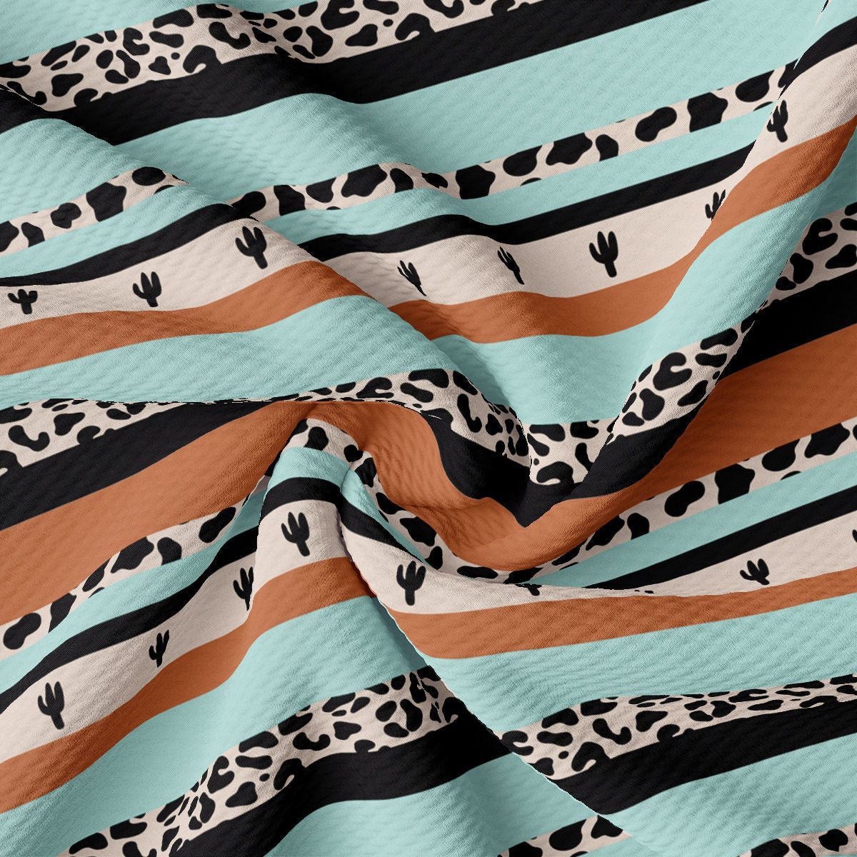 an animal print fabric with stripes and cactus