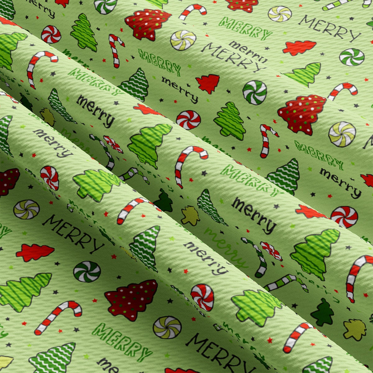 a green wrapping paper with christmas trees and candy canes