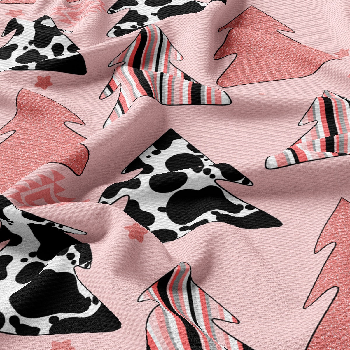 a pink fabric with a cow pattern on it