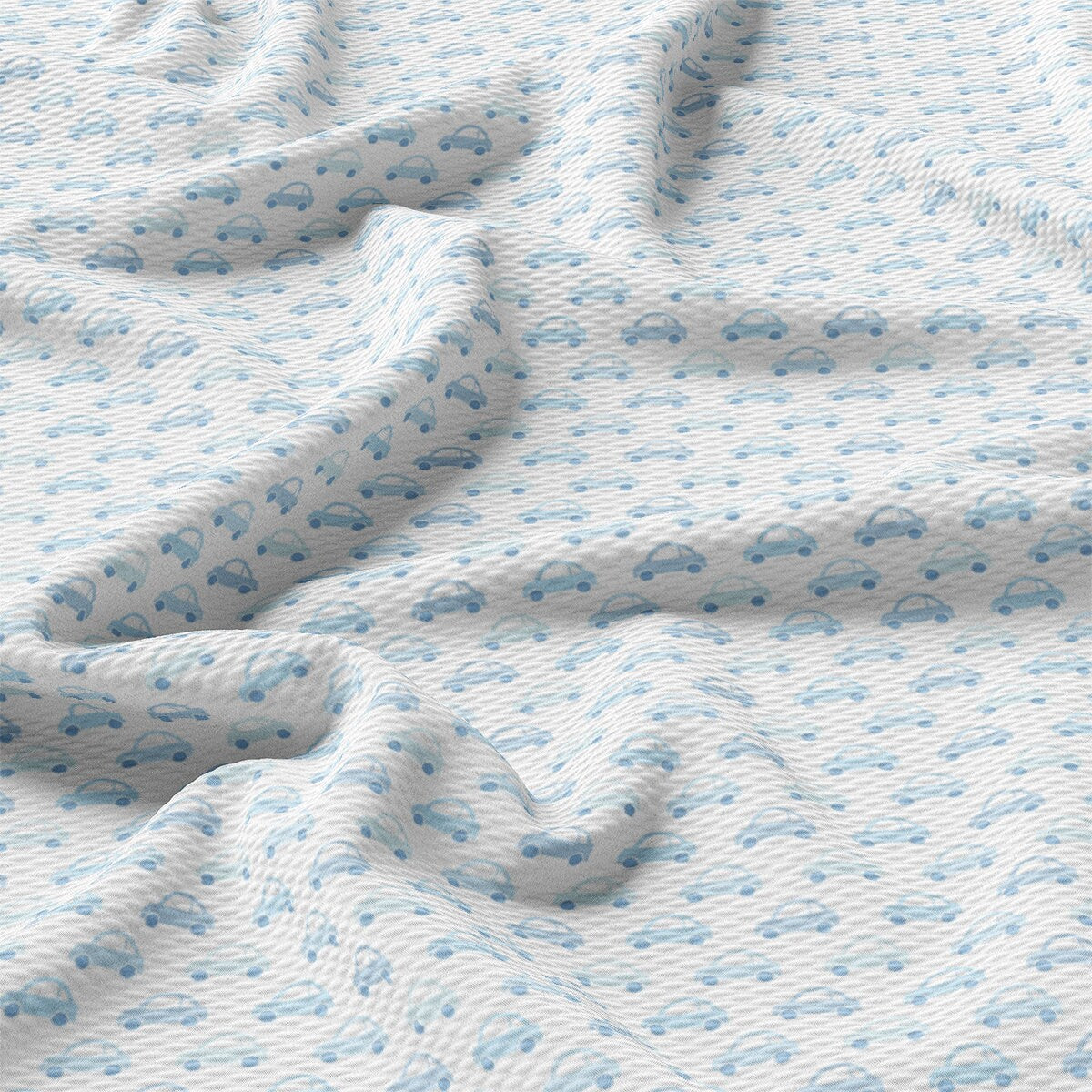 a close up of a bed with a blue and white bedspread