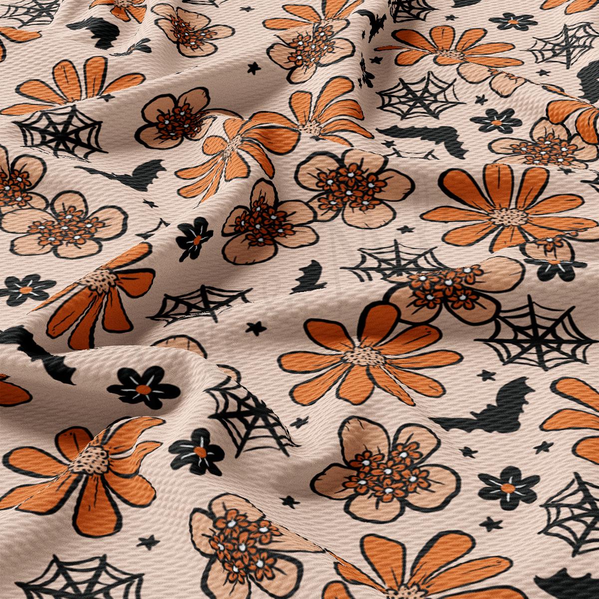 an orange and black flower and spider web fabric