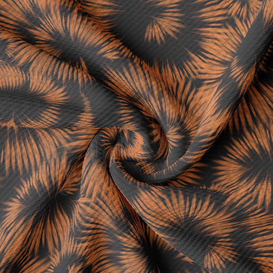 an orange and black fabric with palm leaves