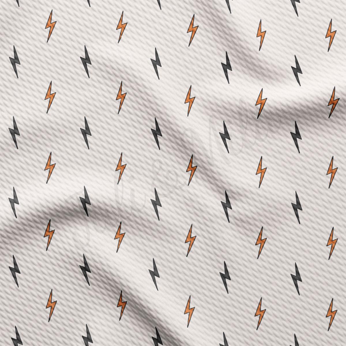 a white fabric with orange and black lightnings on it