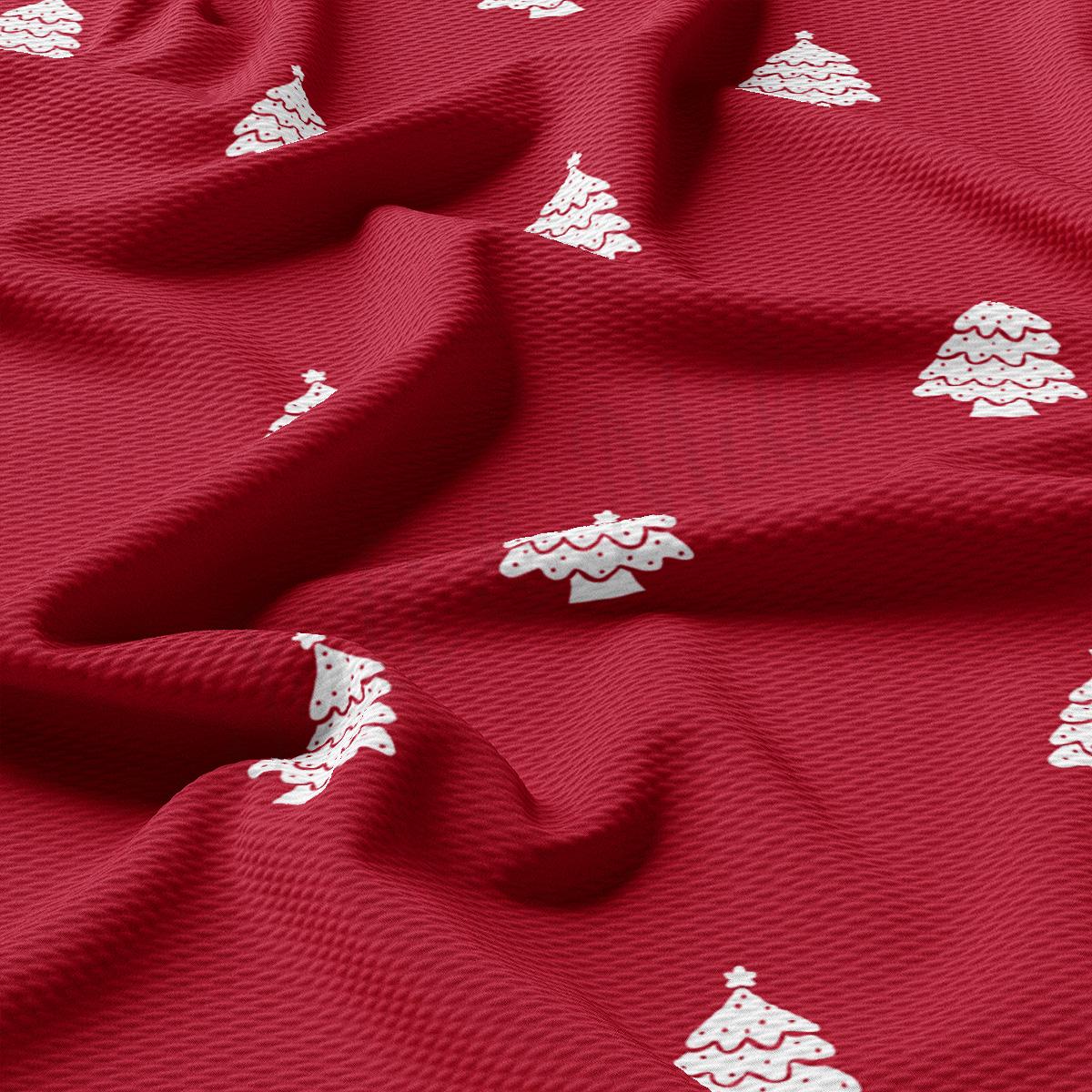 a red fabric with white christmas trees on it