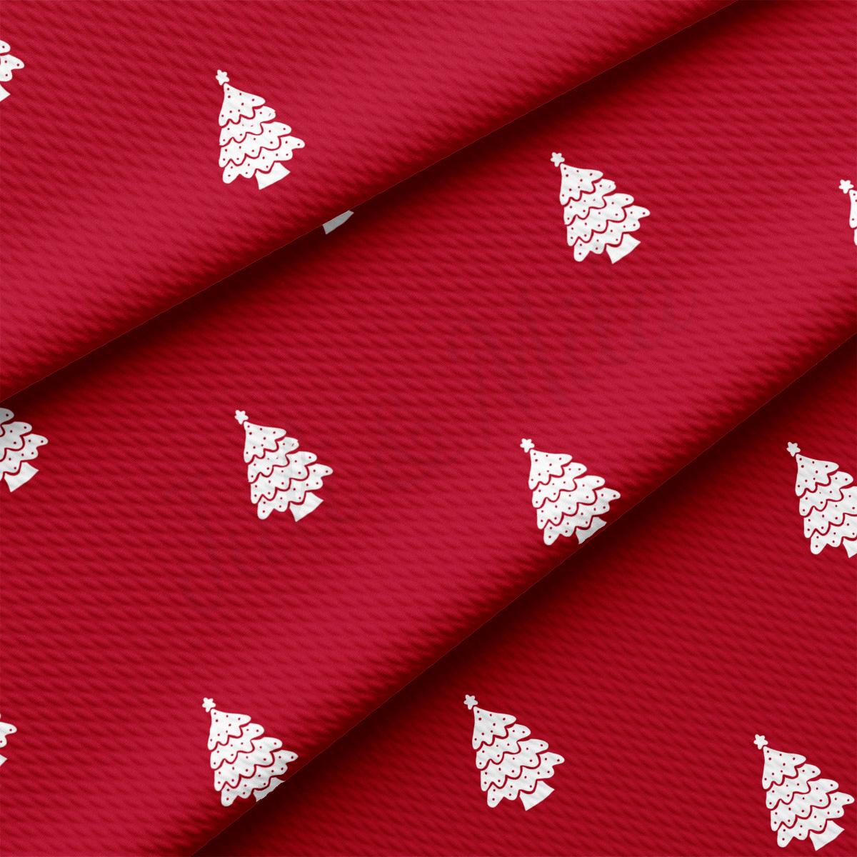 a red fabric with white christmas trees on it