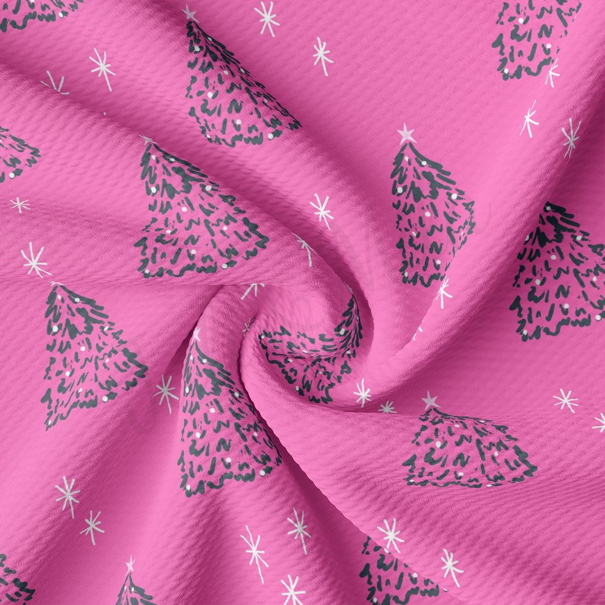 a pink fabric with a christmas tree pattern