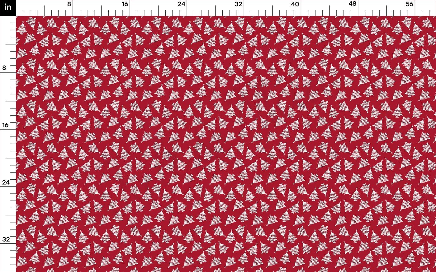 a red and white fabric with white trees on it