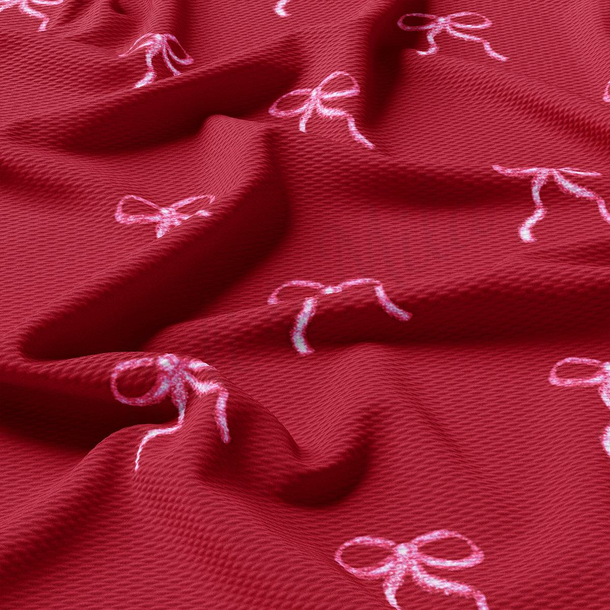 a red fabric with white bows on it