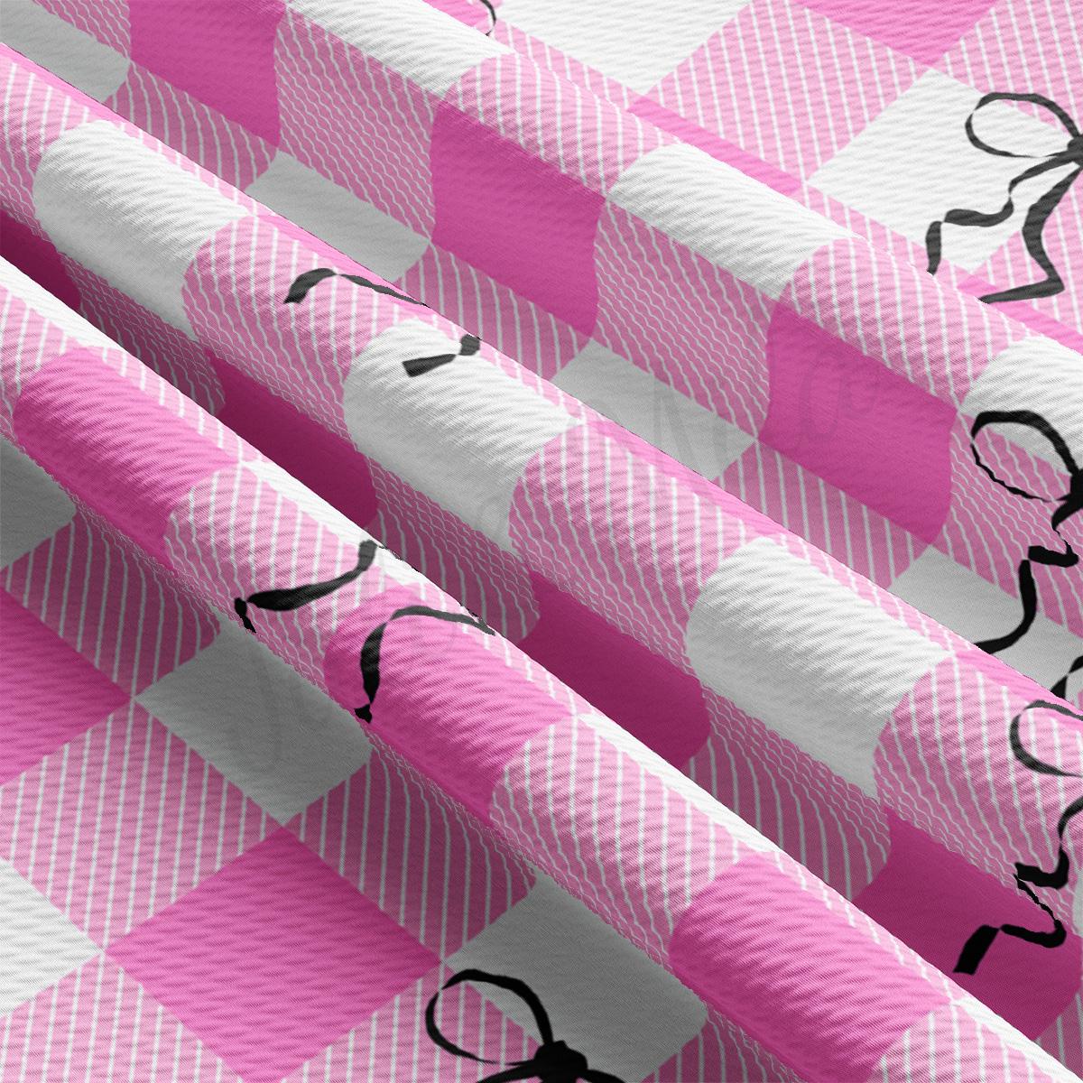 a pink and white checkered fabric with scissors on it