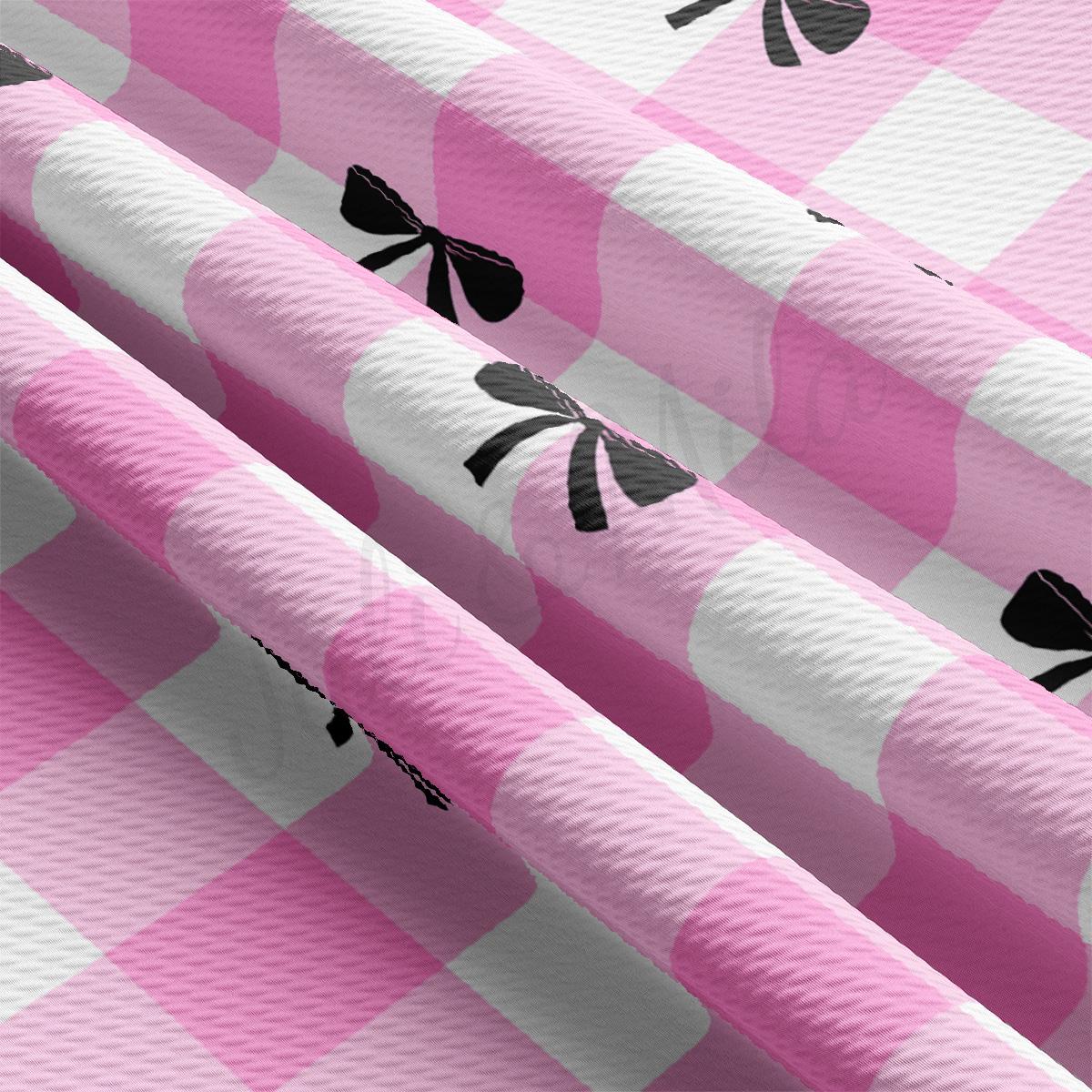 a pink and white checkered table cloth with black playing cards