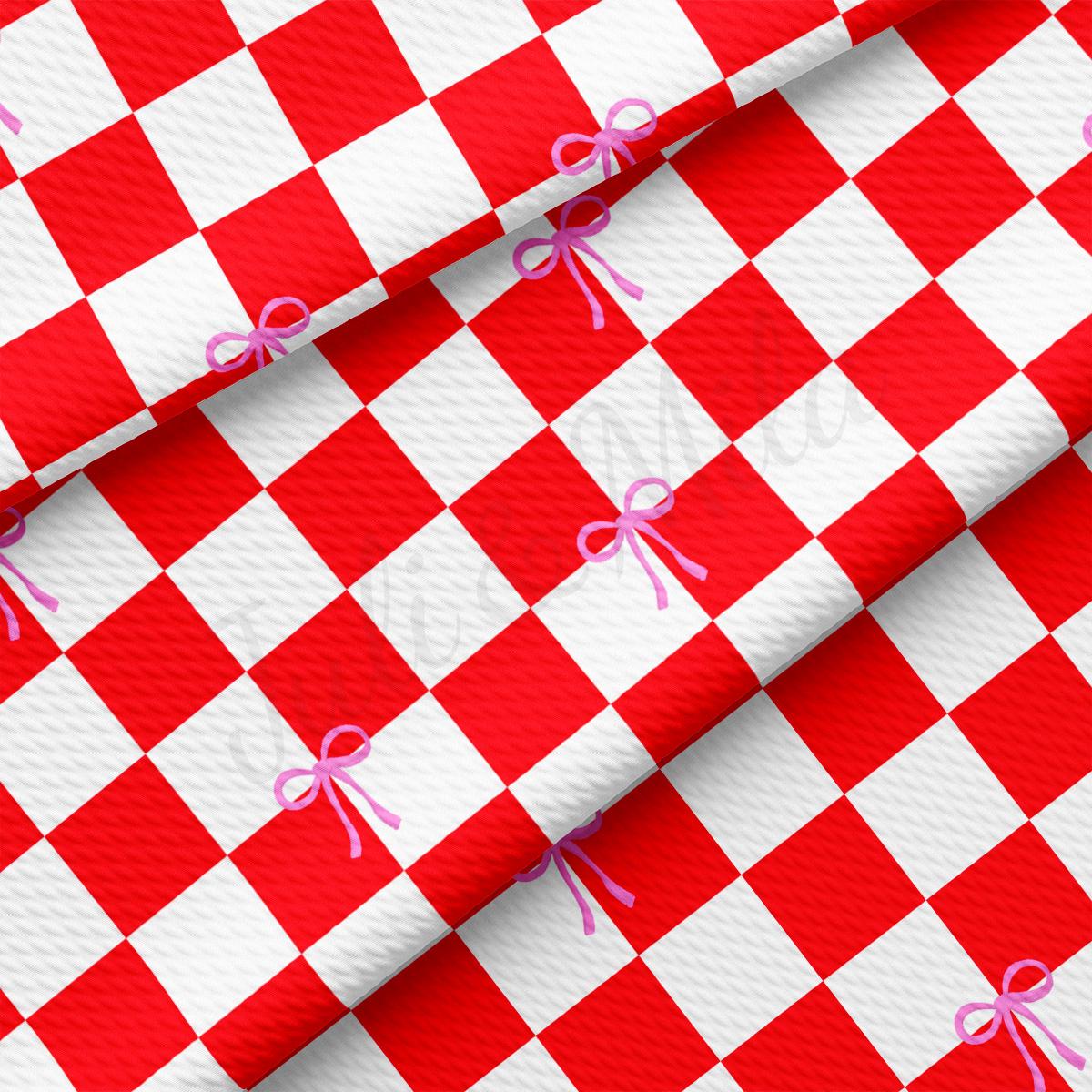 a red and white checkered table cloth with a pink bow