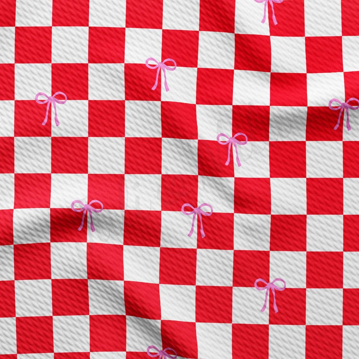 a red and white checkered fabric with pink bows