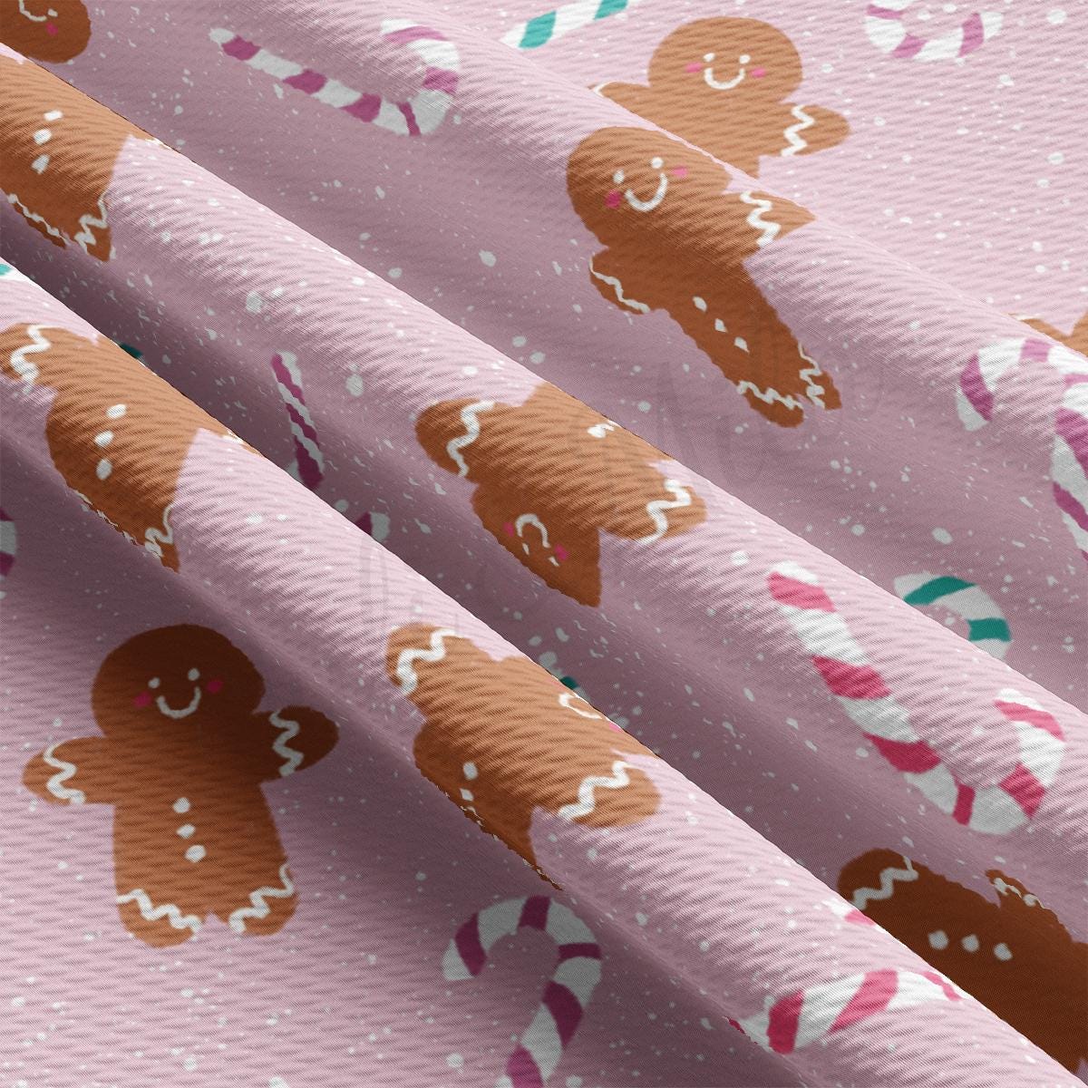 a pink wrapping paper with gingerbreads and candy canes on it