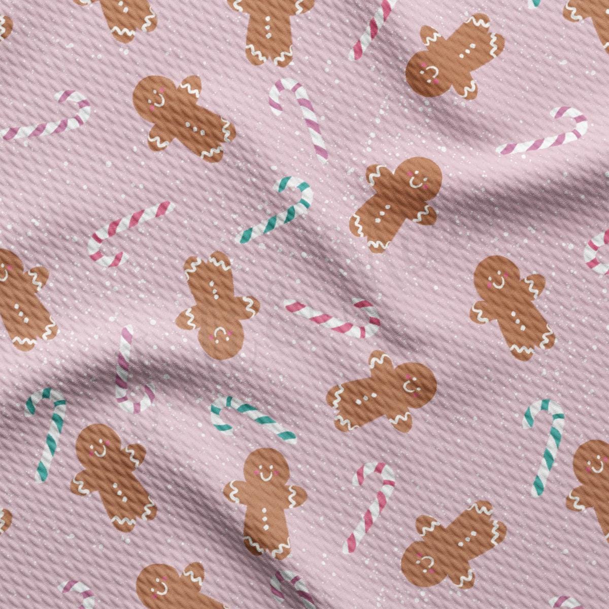 a pink background with gingerbreads and candy canes