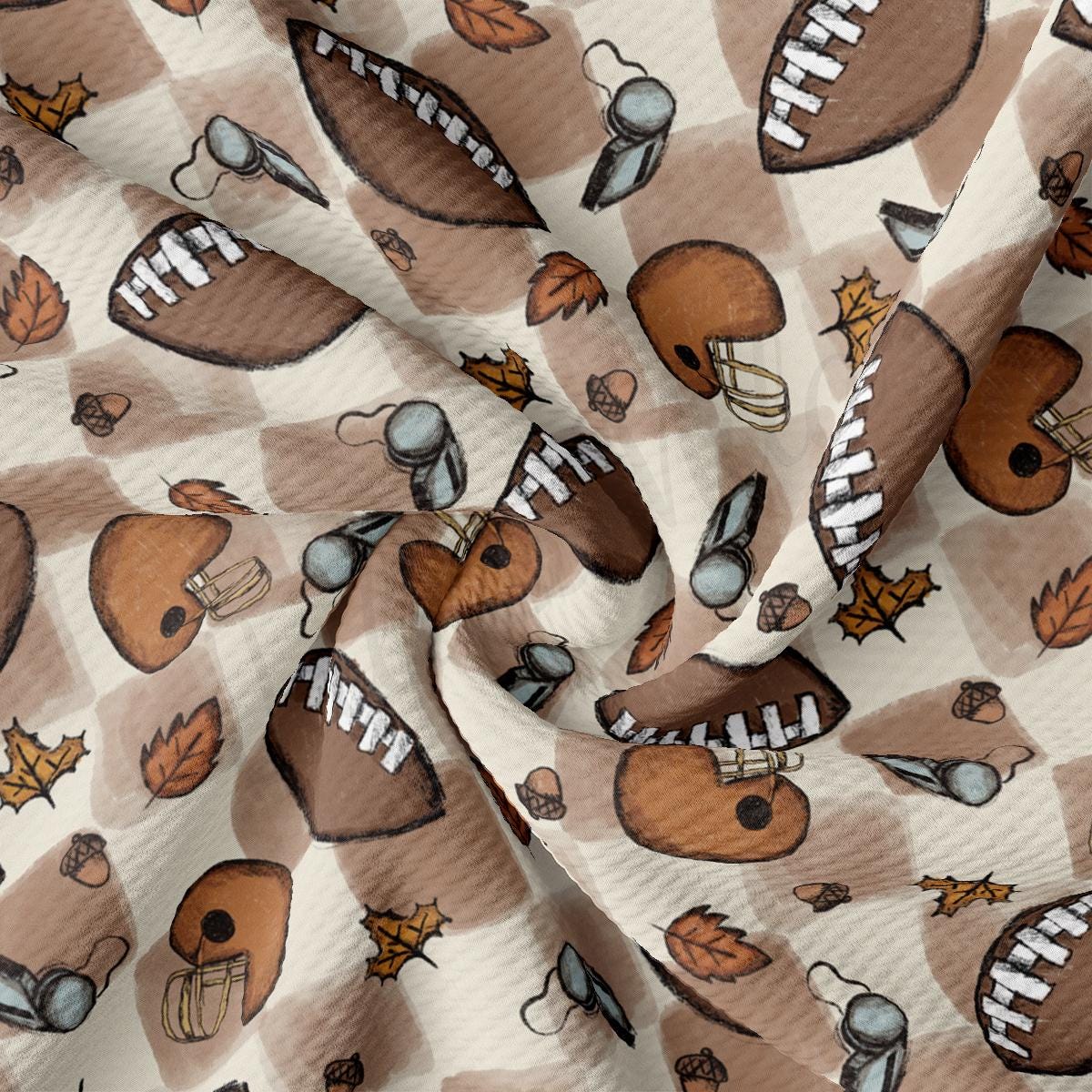 a fabric with footballs and leaves on it