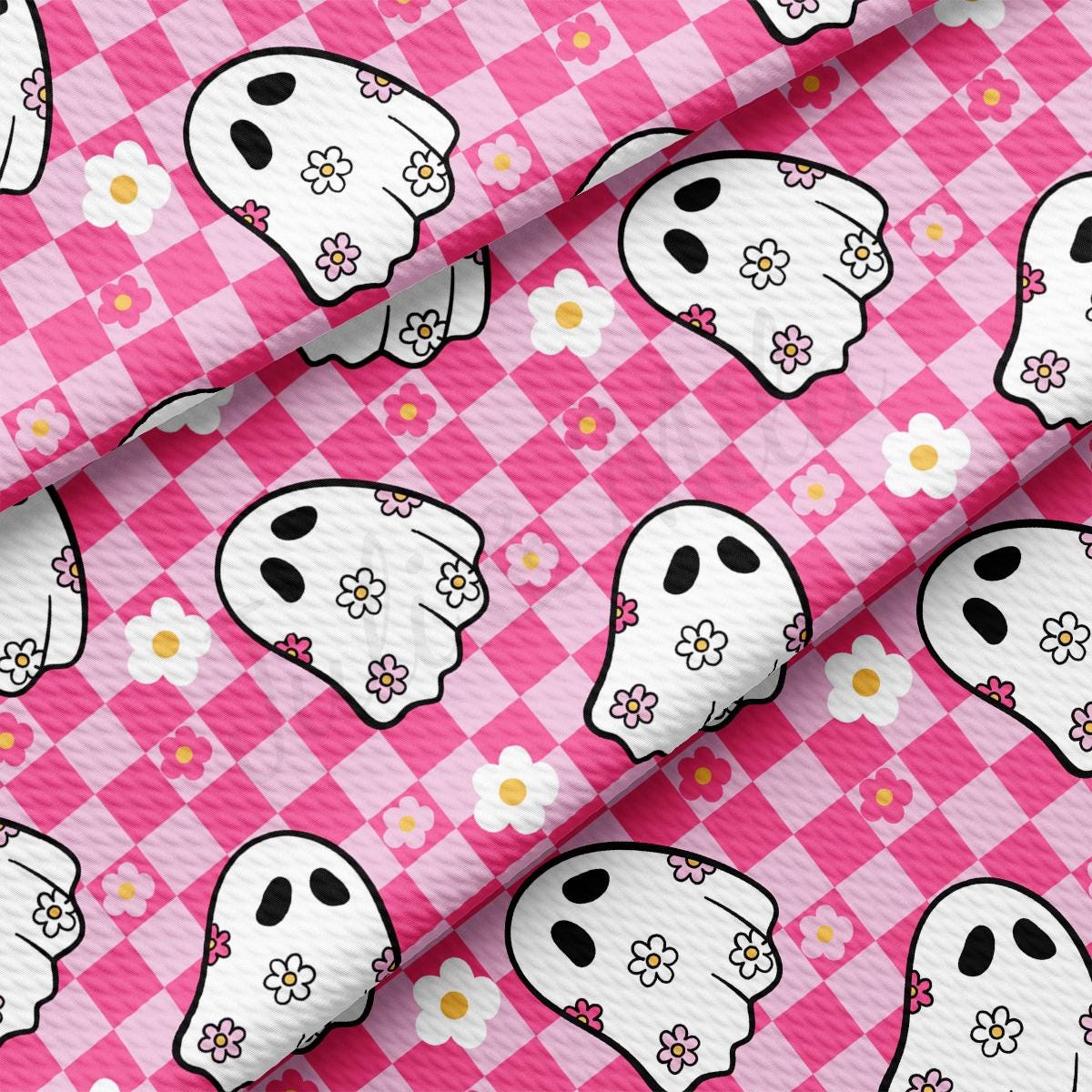 a pink and white checkered fabric with skulls and flowers