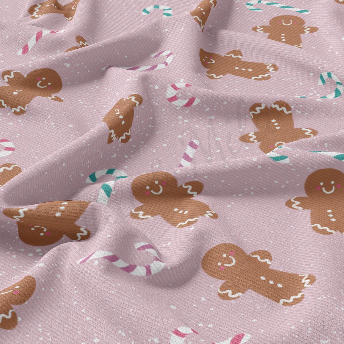 a close up of a pink fabric with gingerbreads on it