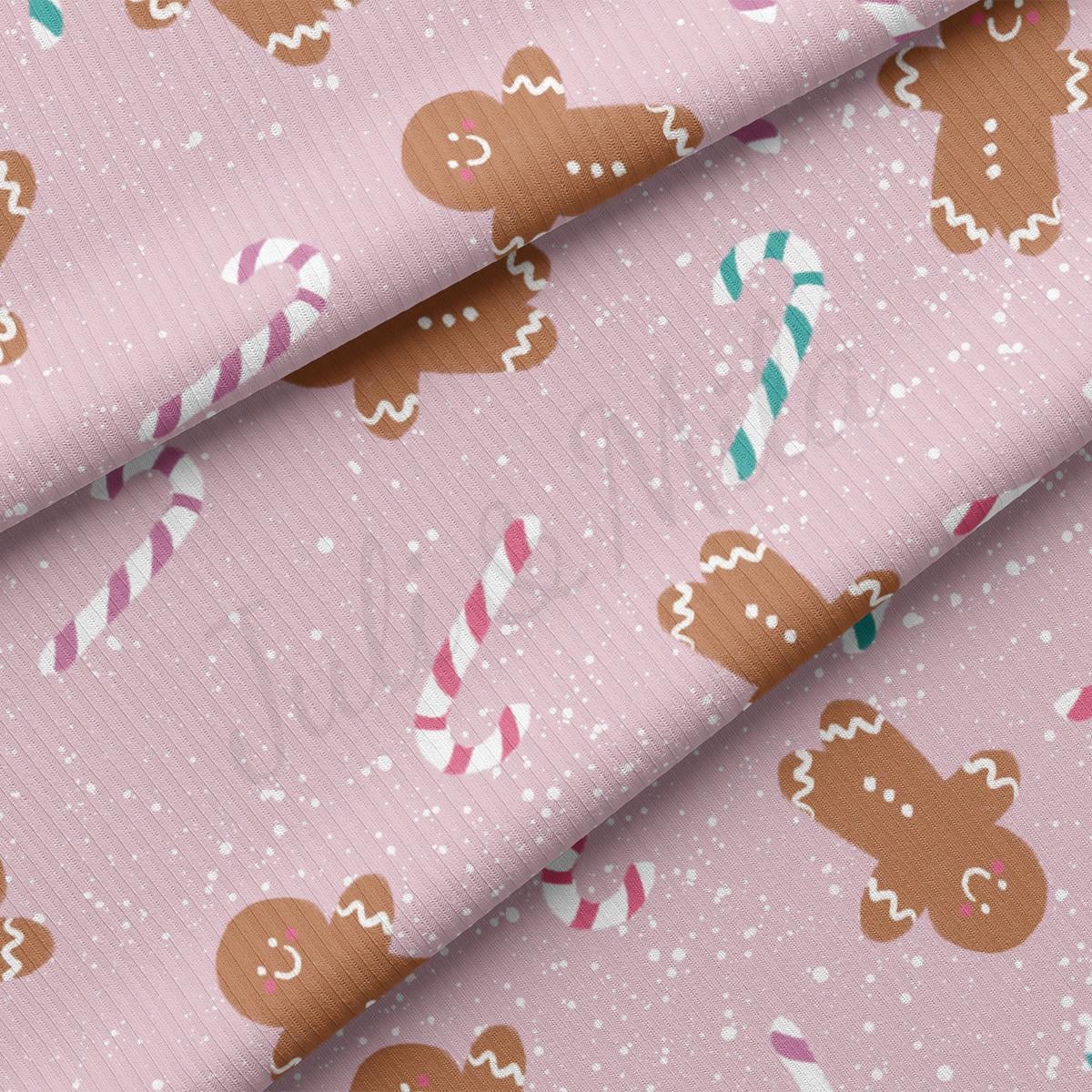 a pink background with gingerbreads and candy canes