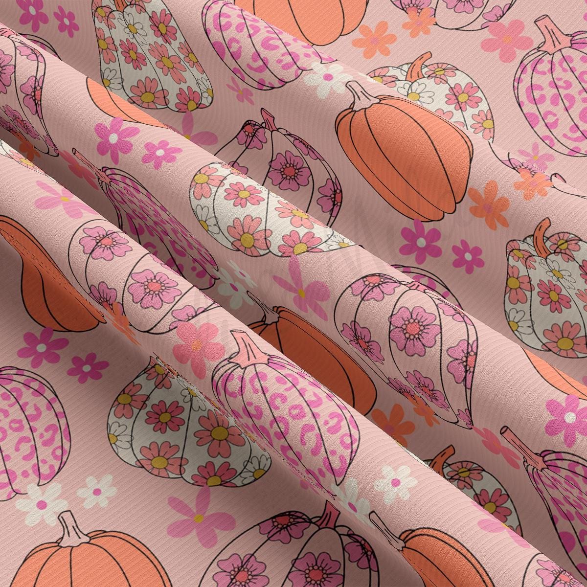 a close up of a pattern of pumpkins on a pink background